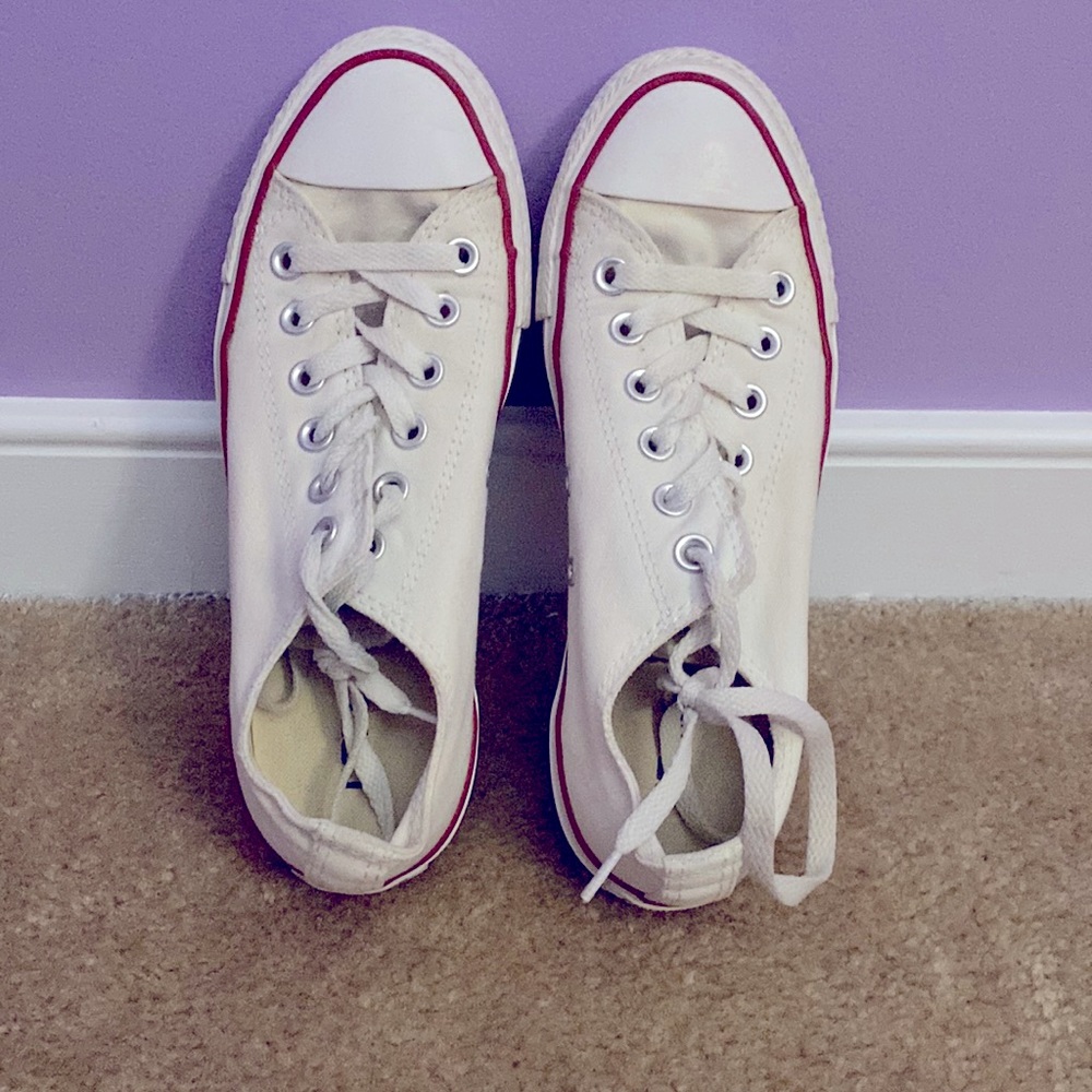 All white converse with a red stripe